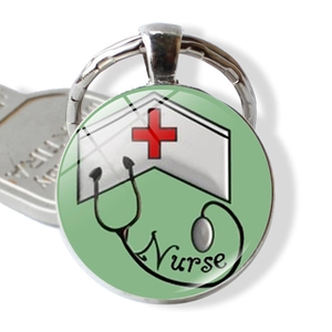 Detail of metal keychain with nurse hat and stethoscope glass cabochon pendant