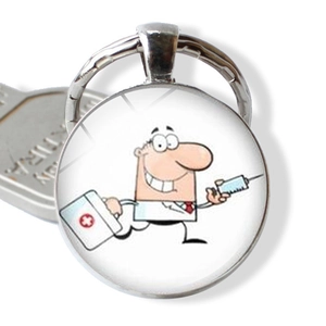 Detail of medical keychain showing a cartoon doctor with syringe and cross medical box