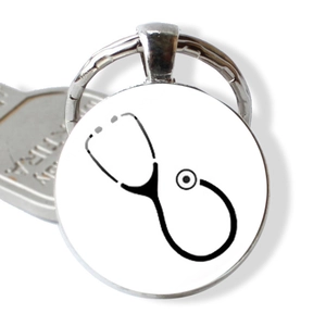 Silver metal medical keychain with a stethoscope icon on a white circular pendant