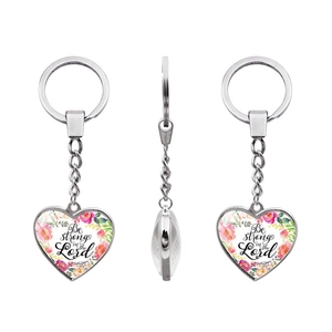 Detail view of heart-shaped keychain featuring Be strong in the Lord floral design