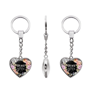 Macro view of heart-shaped keychain with Grace upon grace inscription and floral motifs