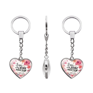 Detail view of heart-shaped keychain with floral pattern and Bible verse Matthew 28:20