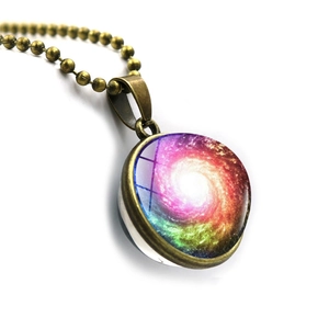 Detailed macro view of the bronze galaxy pendant with spiral nebula art glass sphere