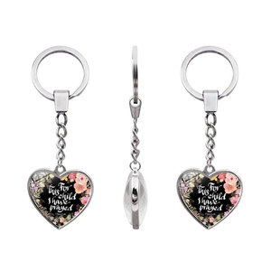 Detailed view of heart keychain with floral design and 1 Samuel 1:27 scripture