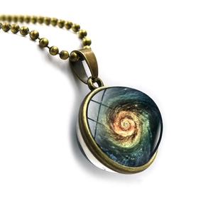Detailed view of bronze space galaxy nebula pendant with double-sided glass orb design