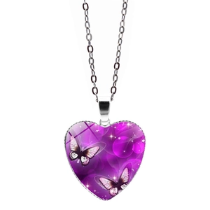 Detail of silver heart pendant with purple butterfly artwork and glass dome finish