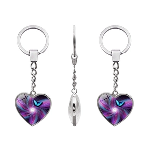 Detailed view of heart-shaped silver keychain with purple nebula and blue butterfly pendant