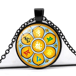 Detail of round glass pendant with yellow lotus and colored Tibetan mantra symbols