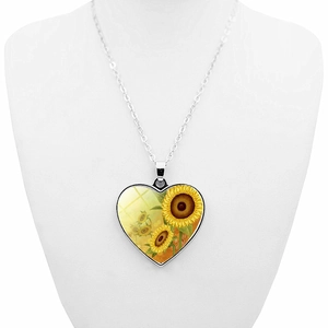 Sunflower double-sided heart pendant necklace on white bust for feminine jewelry display
