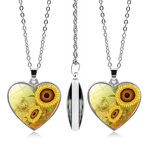 Detailed view of a sunflower heart pendant necklace featuring realistic floral patterns
