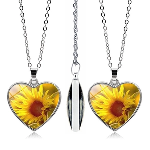 Detailed views of the heart-shaped sunflower pendant necklace showing both sides