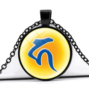 Macro detail of black alloy necklace with yellow glass pendant and blue spiritual symbol