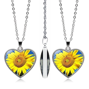 Detailed views of double-sided heart sunflower pendant necklace with silver chain