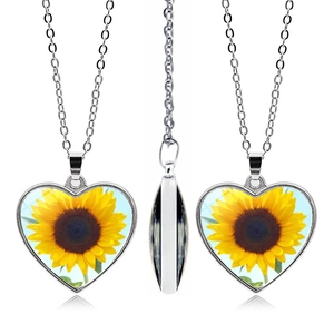 Double-sided heart sunflower pendant necklace in silver finish shown from multiple angles