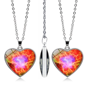 Detail of double-sided heart necklace featuring a vibrant galaxy nebula art pendant