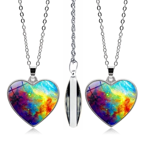 Detail of silver heart necklace featuring colorful galaxy nebula patterns on glass