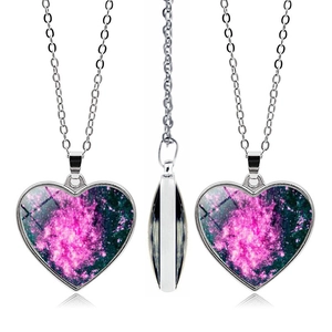 Three-sided view of heart-shaped nebula necklace with silver chain and galaxy pattern