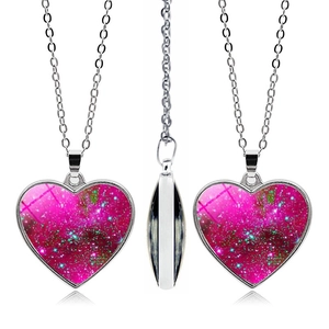 Detailed close-up of heart-shaped galaxy pendant with pink nebula design on white background