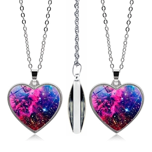 Three-view shot of heart-shaped galaxy nebula pendant with silver chain on white background