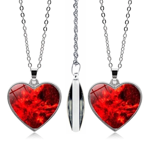 Three-sided view of double-sided heart necklace featuring a red galaxy nebula pattern