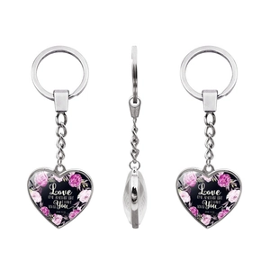 Macro view of heart pendant keychain with John 13:34 scripture and floral pattern