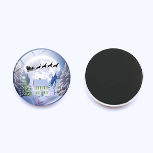Macro view of Christmas fridge magnet showing winter scene patterns and black magnetic base