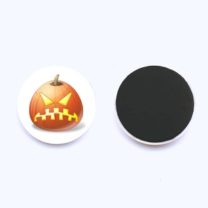 Detail of a 30mm round Halloween fridge magnet showing pumpkin pattern and magnetic back
