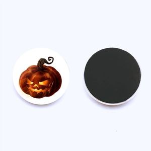 Macro view of 25mm round glass pumpkin fridge magnets with black magnetic backing
