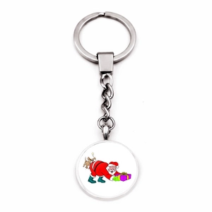 Detailed view of silver Christmas keychain with funny Santa and dog cartoon pendant