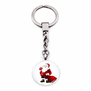 Macro detail of silver metal keychain with festive Santa Claus cartoon glass pendant