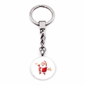 Macro detail of silver metal keychain featuring a festive cartoon Santa Claus pendant