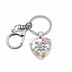 Detailed close-up of heart keychain with Proverbs 31:10 quote and floral design