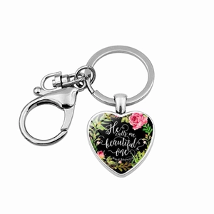 Silver heart keychain with rose floral design and He calls me beautiful one text