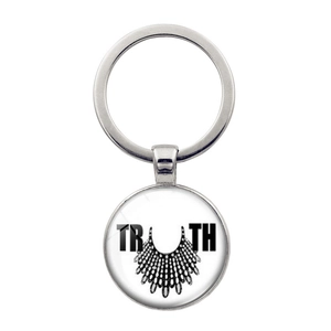 Silver metal keychain with TRUTH pendant featuring iconic RBG lace collar design details