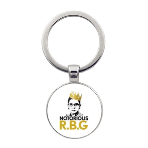 Detailed view of Ruth Bader Ginsburg portrait on a silver-toned metal round keychain
