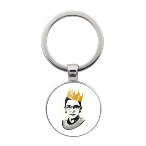 Macro detail of Ruth Bader Ginsberg RBG glass dome pendant keychain with silver ring
