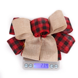 Detail shot of a large buffalo plaid and burlap Christmas bow weighing 23.4g