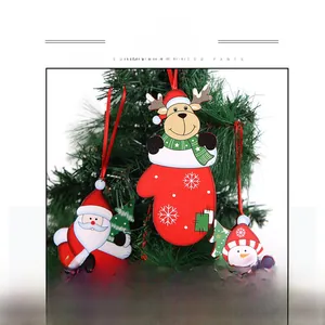 Detail of Santa, reindeer and snowman hanging ornaments on a Christmas tree branch
