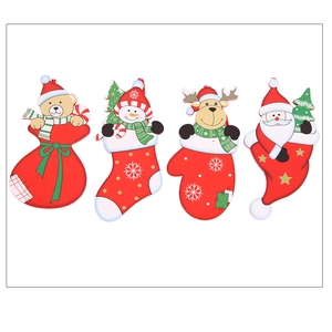Detail of four colorful wooden Christmas ornaments with Santa, elk, and snowman motifs