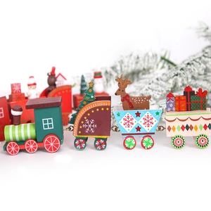 Trenino di Natale in legno verde e rosso con decorazioni festive su sfondo bianco
