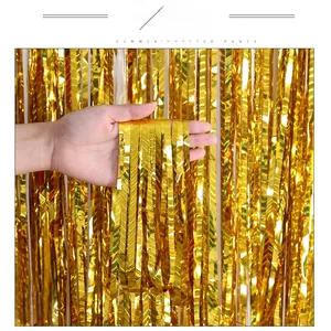 Detail of metallic gold foil fringe curtain with shiny texture for party backgrounds