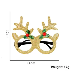 Detail of Christmas reindeer glasses with gold glitter antlers and red pom-poms decor
