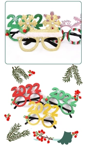 Detail of Christmas party glasses featuring gold snowflake and colorful glitter 2026 frames