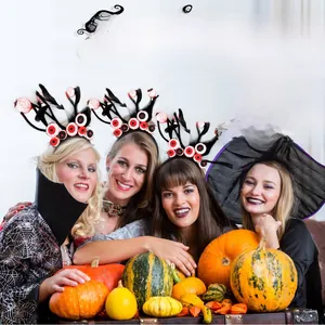 Group of models wearing Halloween eyeball headbands with black feathers and pumpkin decor