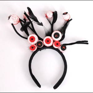 Detail of Halloween headband with spooky bloodshot eyeballs and black feathers decor