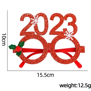 Pink 2023 New Year party glasses with glitter snowflake and holly berry decorations