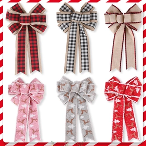 Detail of Christmas ribbon bows featuring reindeer patterns and classic red plaid fabrics