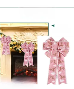 Detailed view of pink burlap Christmas bow with glitter reindeer and white tree patterns