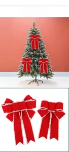 Detail of red velvet Christmas bows with white faux fur trim for festive tree decoration