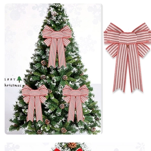 Close-up of a large red and white striped Christmas bow for festive tree decoration
